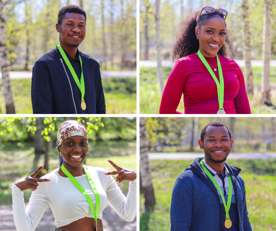 Four Sakustars medalists posing outside with their medals.